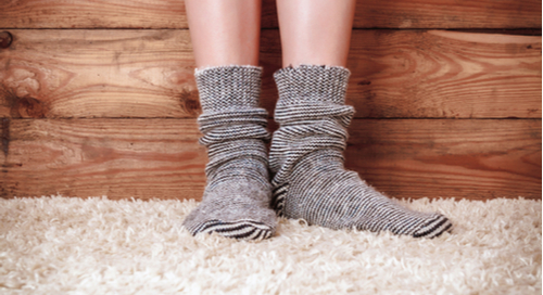 person wearing socks on a carpet