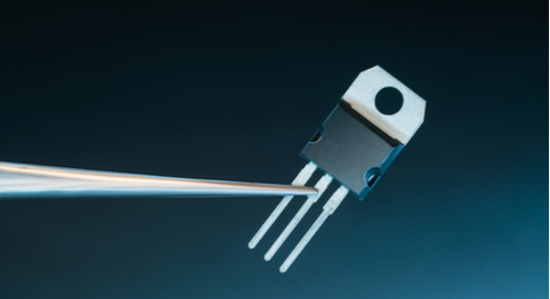 Power transistor on blue background with metal jutting out