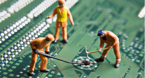 Construction worker figurines on a printed circuit assembly