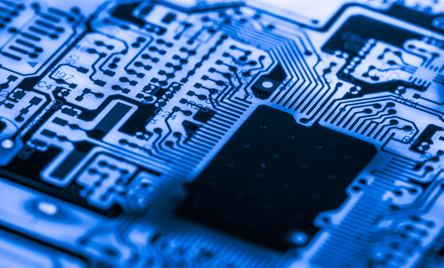 Close-up electronic device on a blue PCB